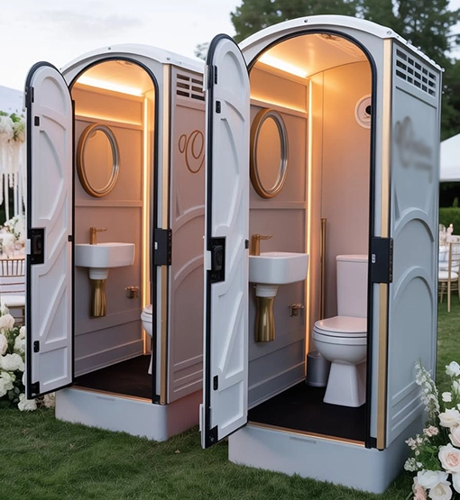 Luxury Portable Restrooms with Gold Fixtures at an Outdoor Event